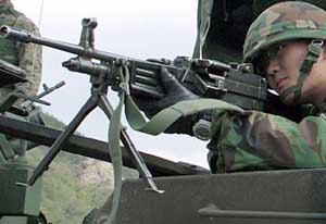 Front left side view of the Daewoo K3 light machine gun; note bipod and forward sight